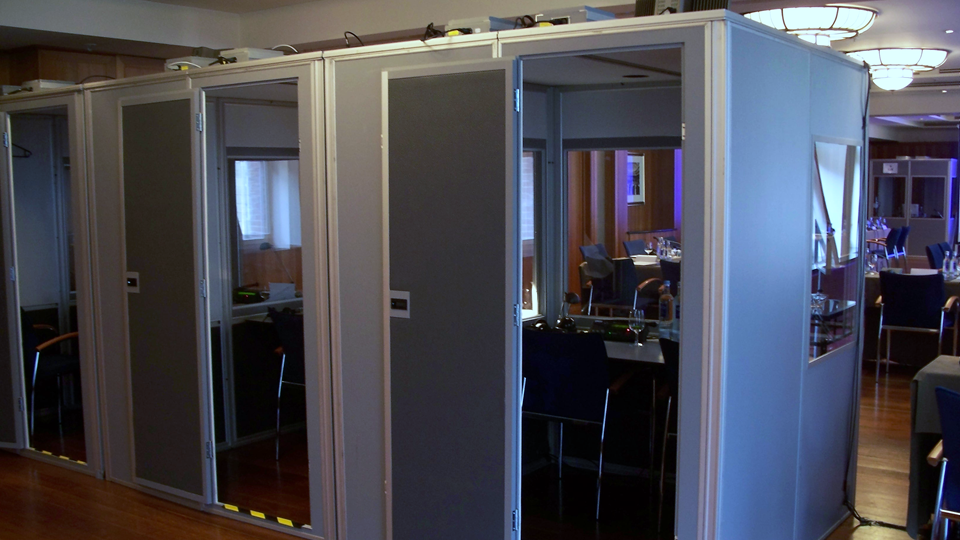 Description: Interpreter booths placed directly in the room. This setup is also used in interpreting centers.