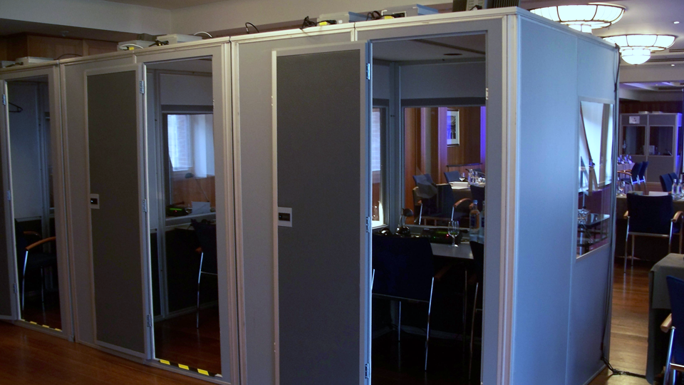 Description: Interpreter booths placed directly in the room.